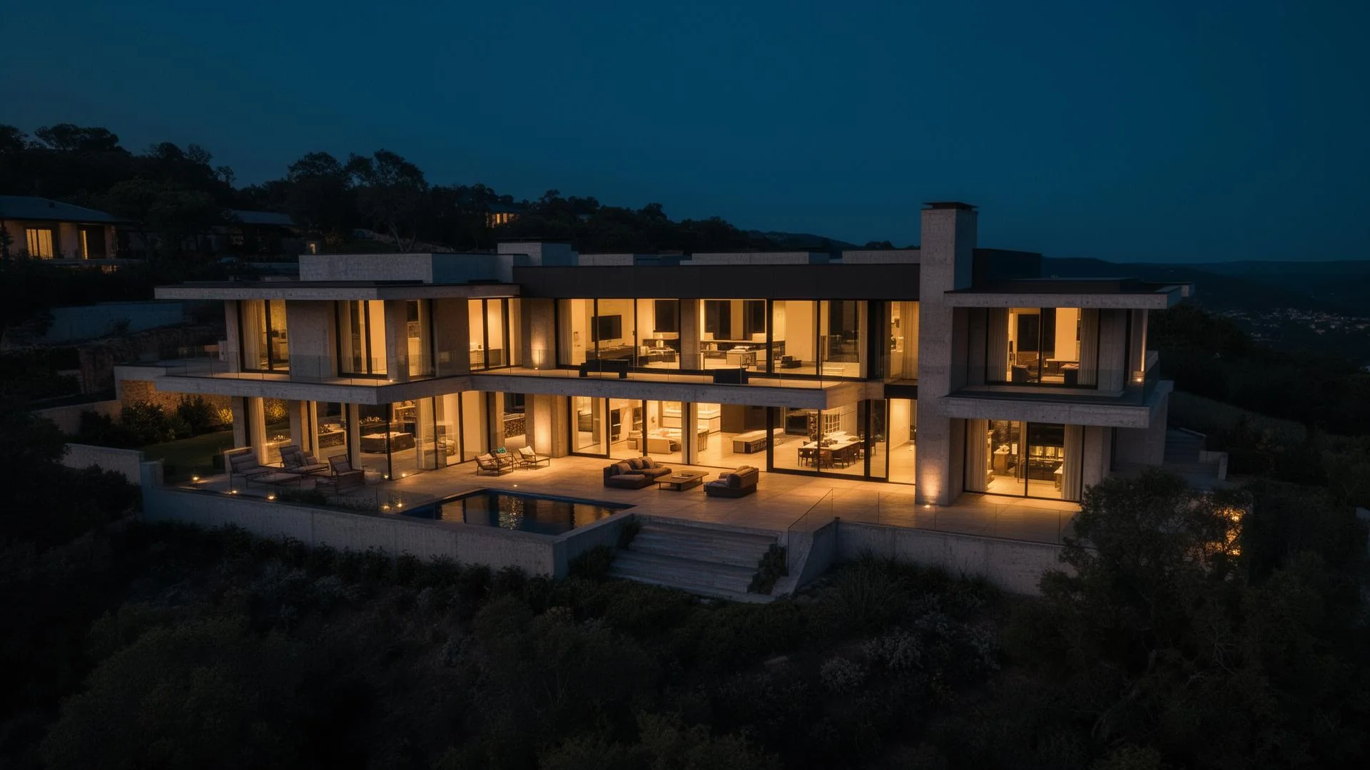 Modern luxury home and illuminated pool at dusk